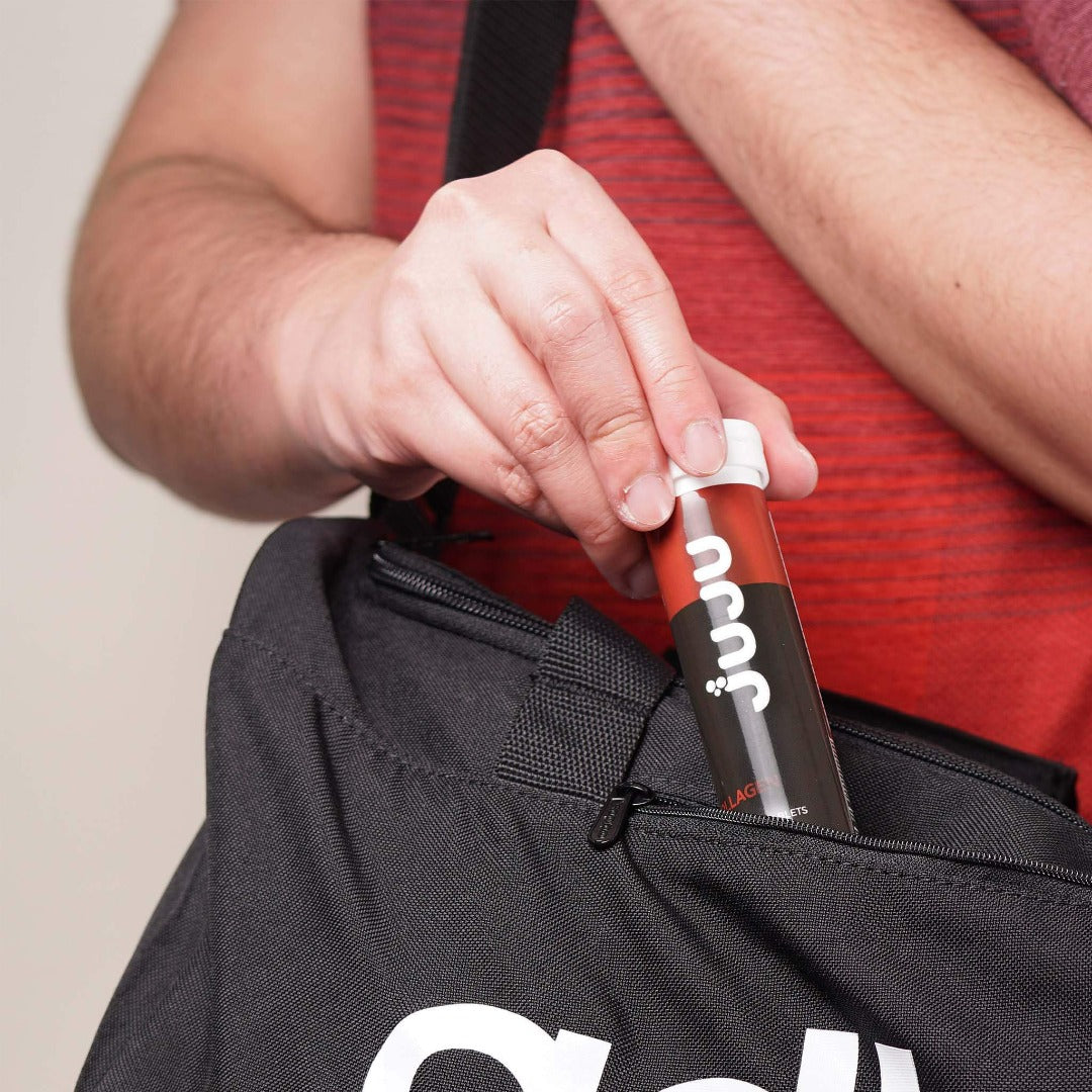 Man Sliding His Juju Collagen with Vitamin C Effervescent Tablets in His Sling Bag