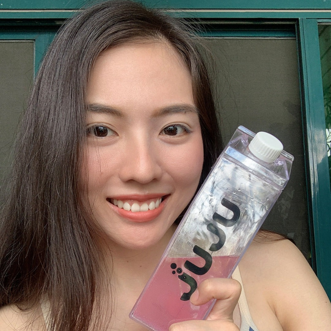 Woman holding her tumbler of berry-flavored collagen effervescent tablets
