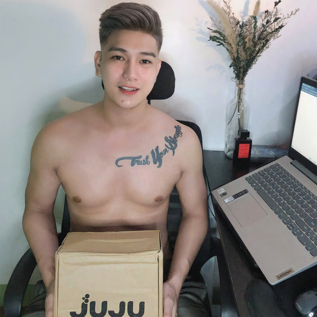 Male customer holding his box of Juju Collagen with Vitamin C.
